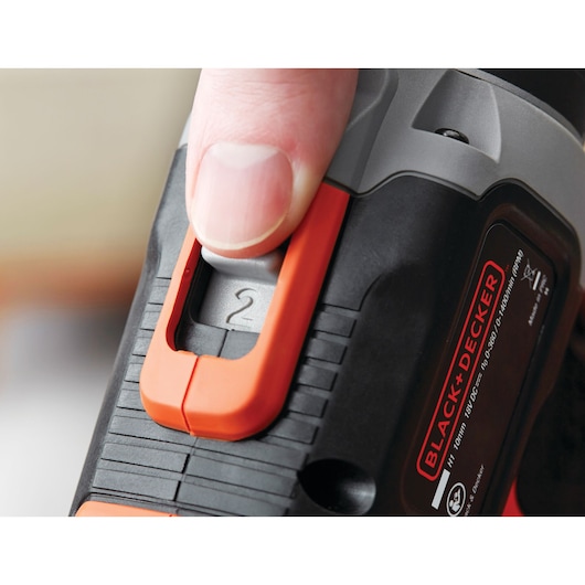 Close-up of BLACKDECKER drill speed selector, orange and black finish, SKU BCK21S1S.