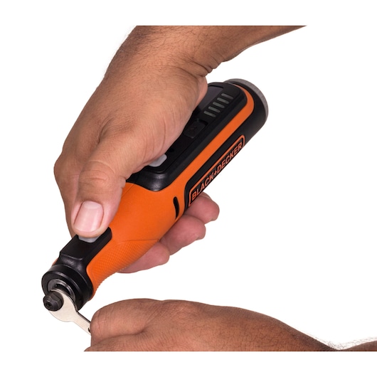 Photo of BLACKDECKER BCRT8K35 orange rotary tool in hand, showing tool adjustment on white background.