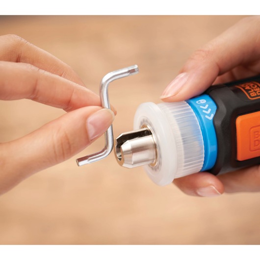 Photo of BLACKDECKER BCRTA601I electric screwdriver close-up, showing attachment of a hex key to the chuck.