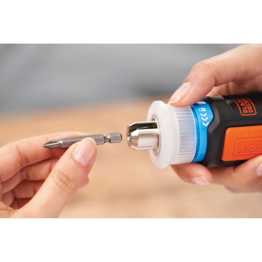 Photo of BLACKDECKER BCRTA601I screwdriver being fitted with a drill bit, close-up hand view.