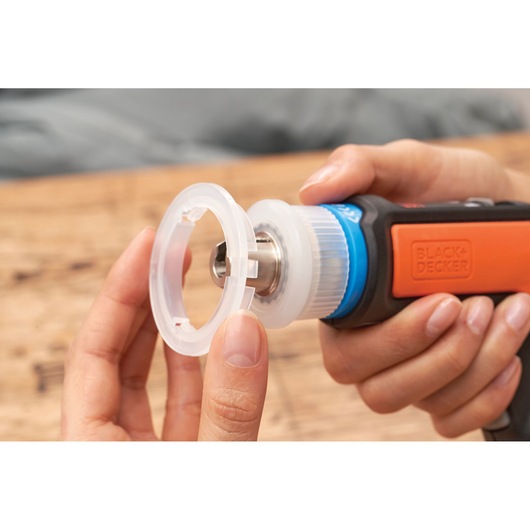Photo of BLACKDECKER rotary tool BCRTA601I with plastic accessory being attached, close-up view.