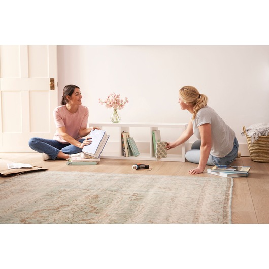 BLACKDECKER BCRTA601I cordless screwdriver in use for home bookshelf assembly on hardwood floor.