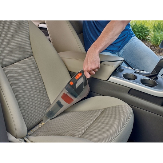 BLACK+DECKER BDCV370-LA handheld vacuum cleaning crumbs from a car seat interior.