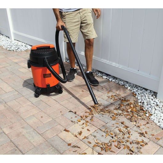 BLACKDECKER BDWD15 wet dry vacuum cleaning patio leaves, orange and black, outdoor usage.