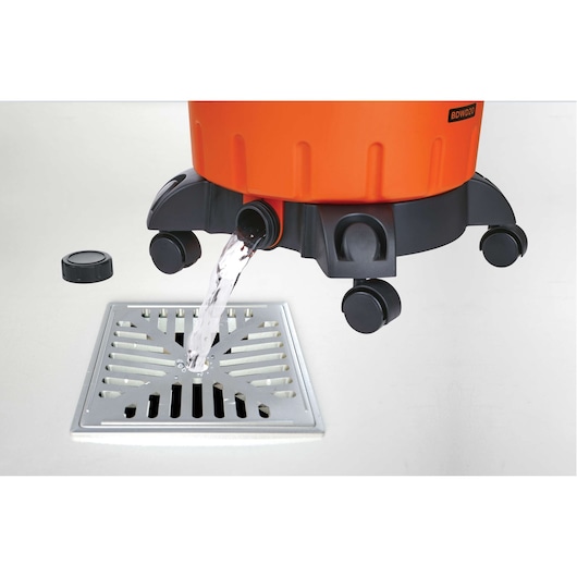 BLACKDECKER BDWD20 wet and dry vacuum draining water from drain spout into floor grate, side angle.
