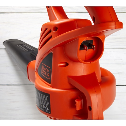 Photo of BLACKDECKER LB700 electric leaf blower, close-up side angle showing power cord inlet and handle.