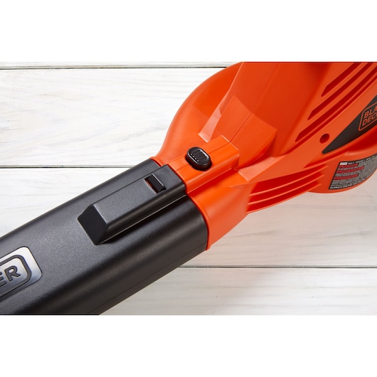 BLACKDECKER LB700 leaf blower close-up, orange and black, showing control button, side angle.