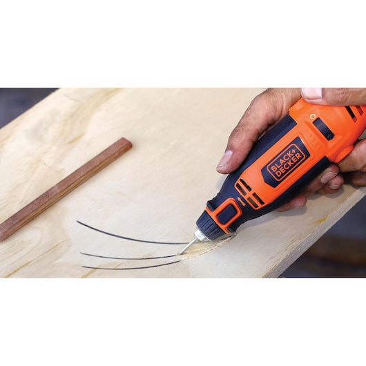 Photo of BLACK+DECKER RT18KA rotary tool used for wood carving, orange and black handheld design.