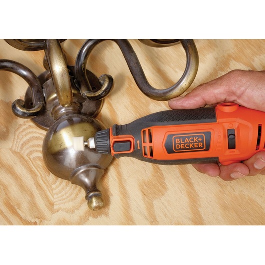 Photo of BLACKDECKER RT18KA rotary tool polishing metal fixture on wooden surface.